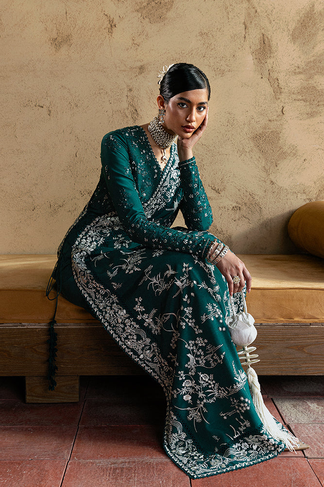 Suffuse Amarien teal Pakistani wedding outfit seated full-length view