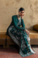 Suffuse Amarien teal Pakistani wedding outfit seated full-length view